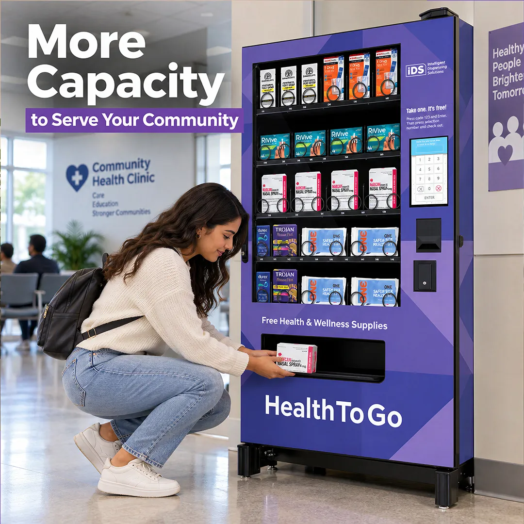 Visitor accessing supplies from an IDS refrigerated vending machine in a health center